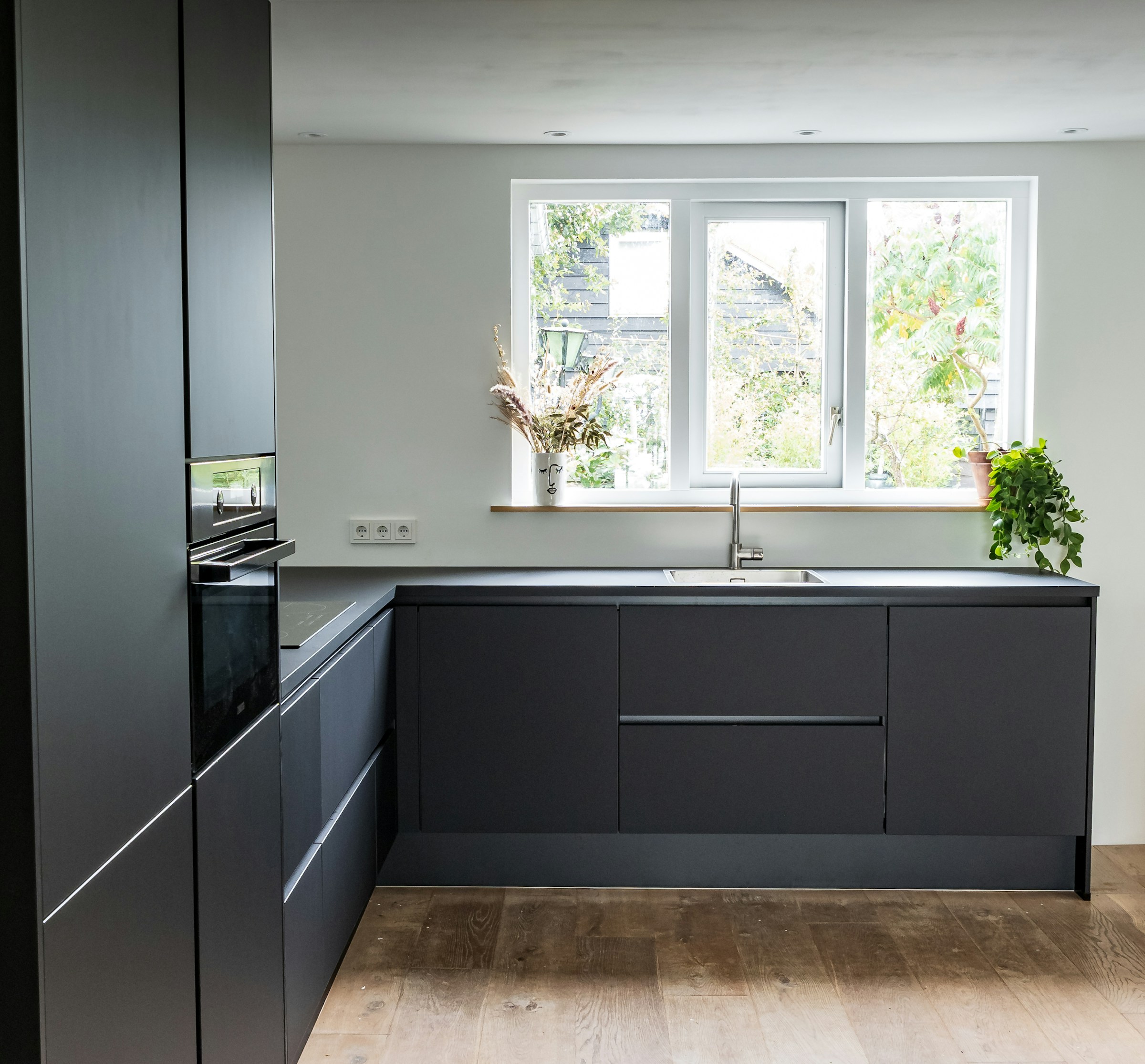Matte charcoal wrapped kitchen cabinets